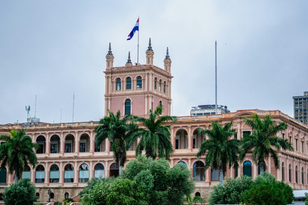 Historic building with palm trees in Asunción, Paraguay — a low-cost capital city popular with remote workers and expats seeking fast residency