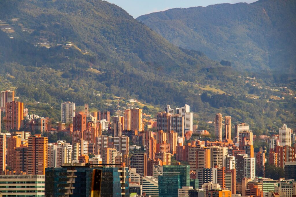 Aerial view of Medellín, Colombia with mountains in the background — a popular destination for American expats seeking a lower cost of living